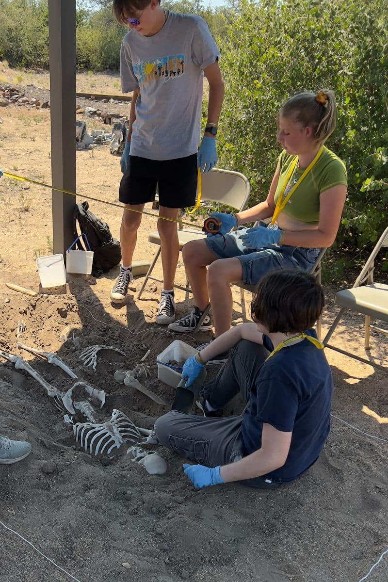 High school students participate in a simulated excavation.