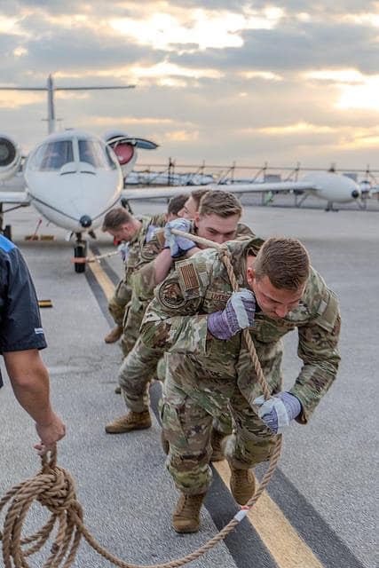 ROTC students pull small plane.