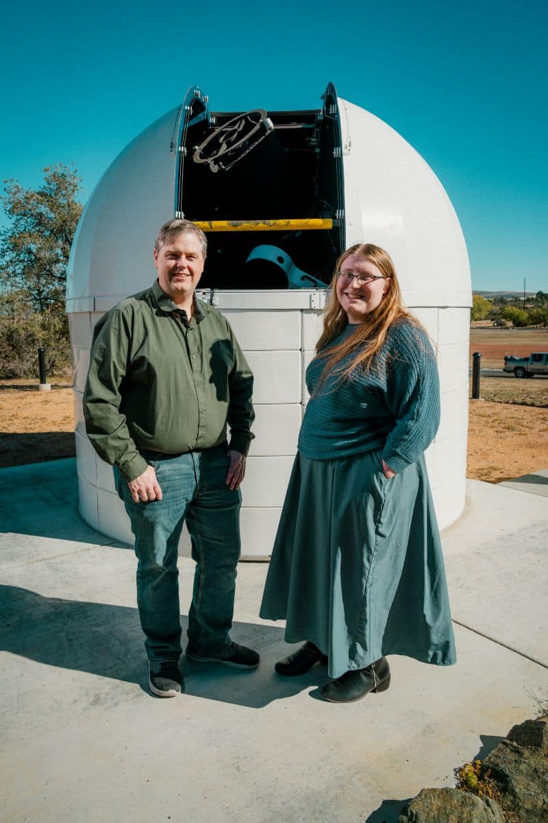 Astronomy student Sola Nova and Dr. Noel Richardson in front of telescope.