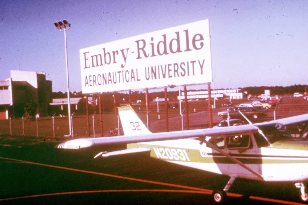 Cessna 172 on flight line in front of Embry-Riddle sign.