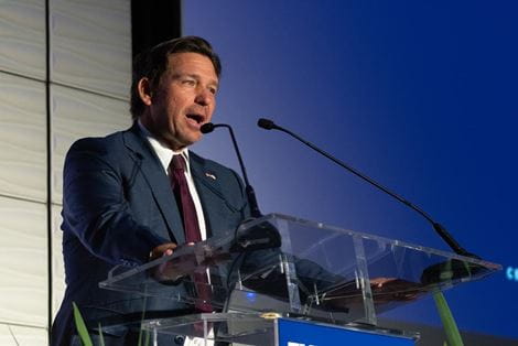 Florida Gov. Ron DeSantis at podium at Embry-Riddle centennial event.