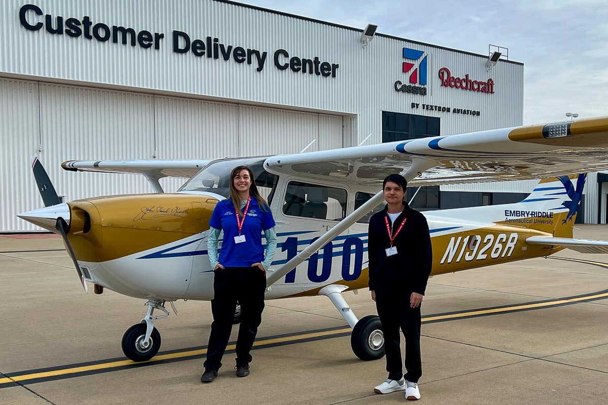 Embry-Riddle Aircraft Technician Korry Noyes and Flight Instructor Rafael Dubena in front of Cessna factory.