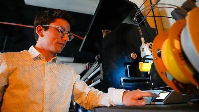 Embry-Riddle undergraduate Justin Fratto works a 3D printer