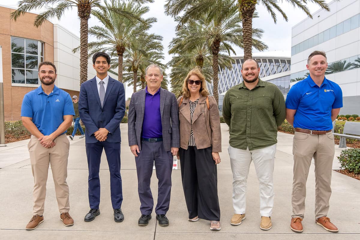 Former Embry-Riddle President Steve Sliwa and his wife, Nancy, stand with three students.