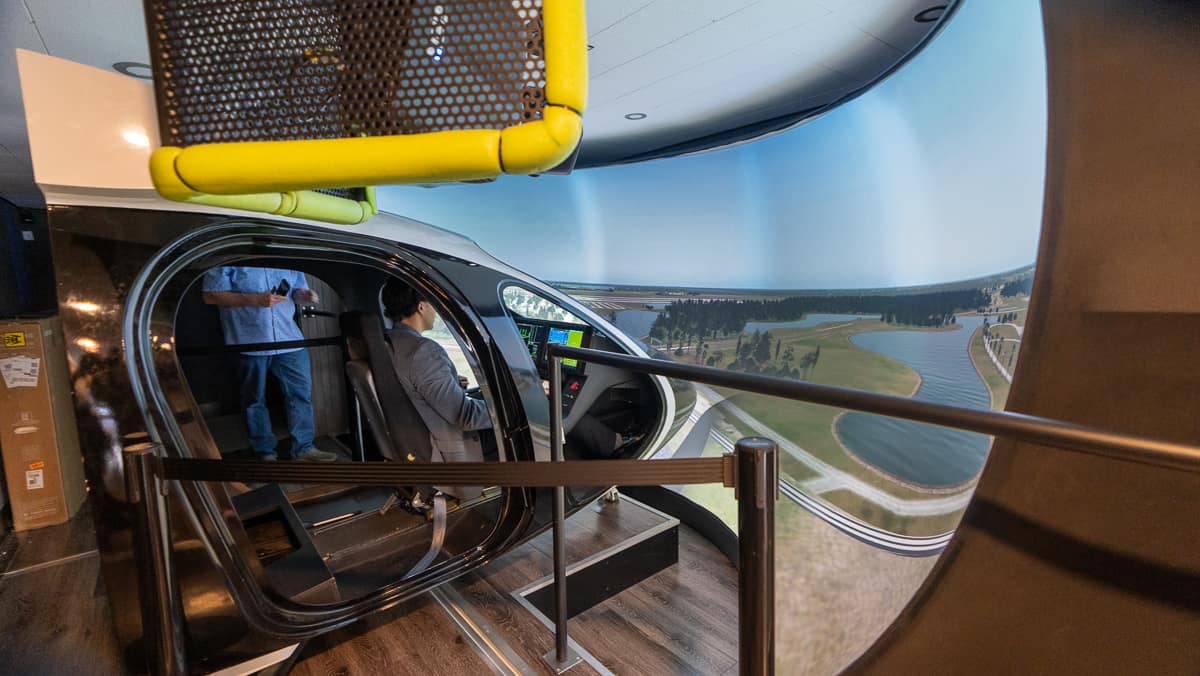 Student in vertical takeoff airplane simulator.