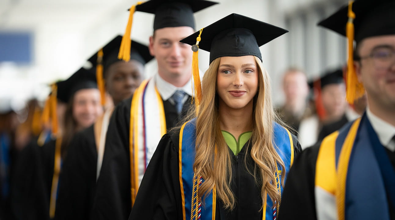 Students in caps and gowns at commencement