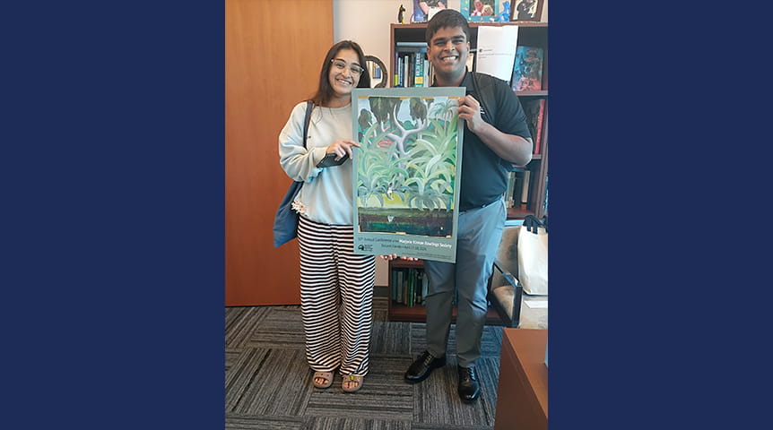 Embry-Riddle students hold an award from a digital media contest.