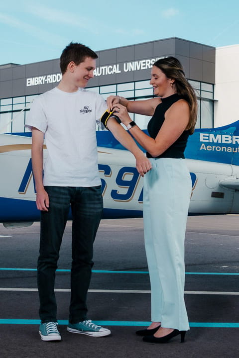 woman wraps dosimeter around man's arm