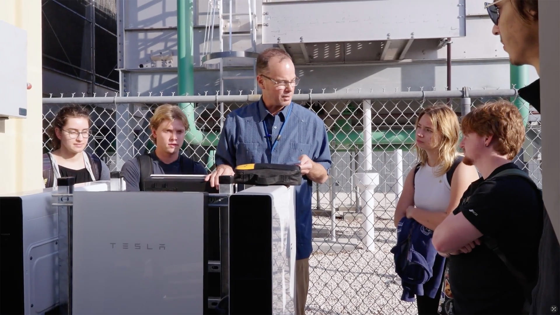 Dr. Currier shows off the Tesla Powerwall in front of a group of students