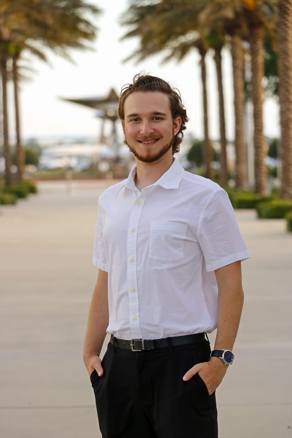 Man stands in front of Embry-Riddle statue 