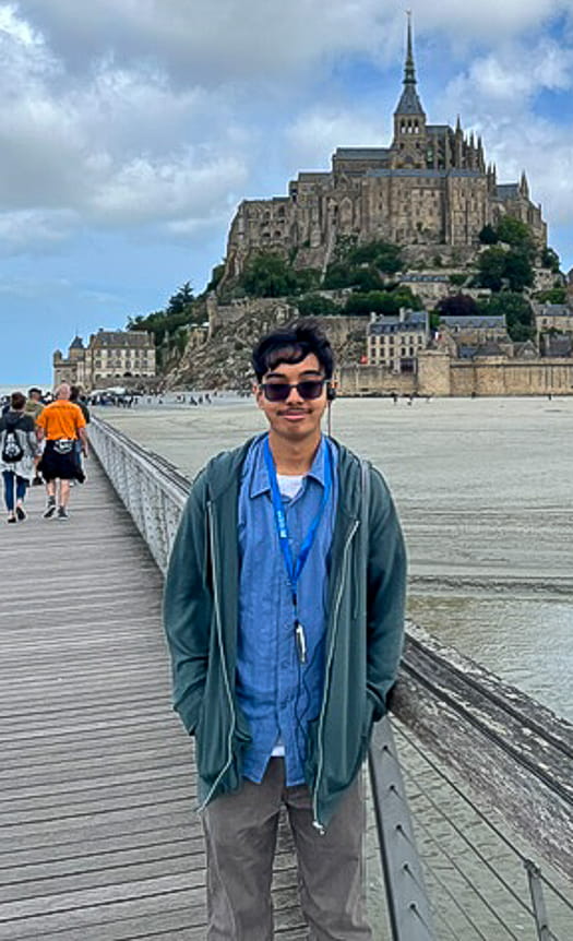 Man in front of Mont-Saint-Michel in Normandy, France
