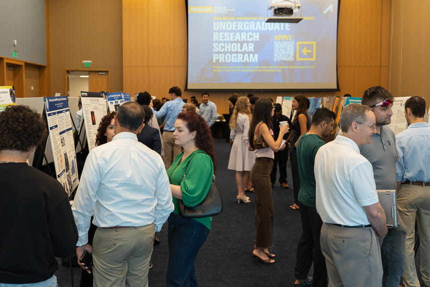 Crowded room of people and research posters
