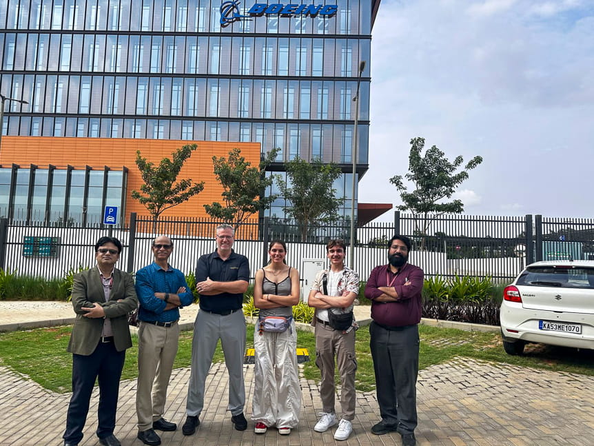 Six people in front of the Boeing India Engineering & Technology Center