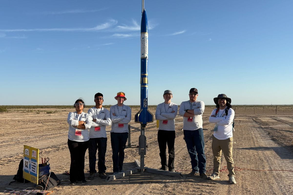 Members and representatives of Embry-Riddle’s Rocket Development Laboratory (RDL) stand beside the team’s 2026 International Rocket Engineering Competition (IREC) rocket entry. From left: Nithya Pattamatta, Dhanush Balusa, Calvin Lindemann, Quentin Trull, Chad Alumbaugh and Bryce Chanes. 