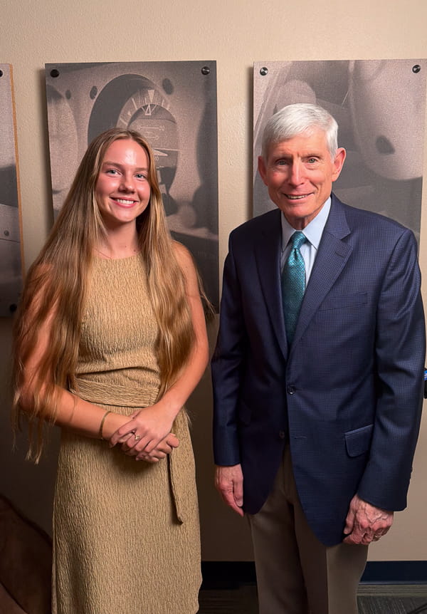 Student Saule Kondra stands next to Gen. Schwartz