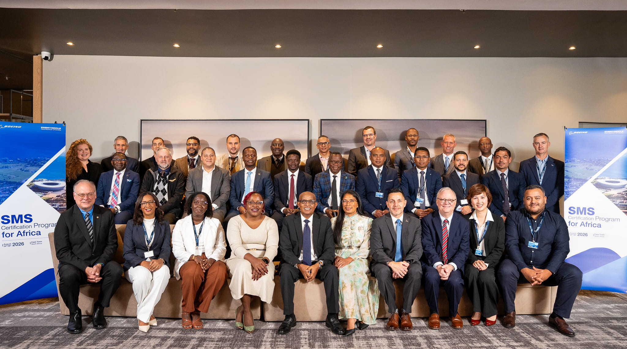 Participants in an Aviation Safety Management Systems (SMS) Certification Program stand together with their instructors for a group photo