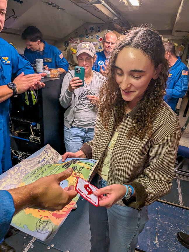 Lauren Báez Sepúlveda receivesd a patch and certificate for having flown through a hurricane's eyewall
