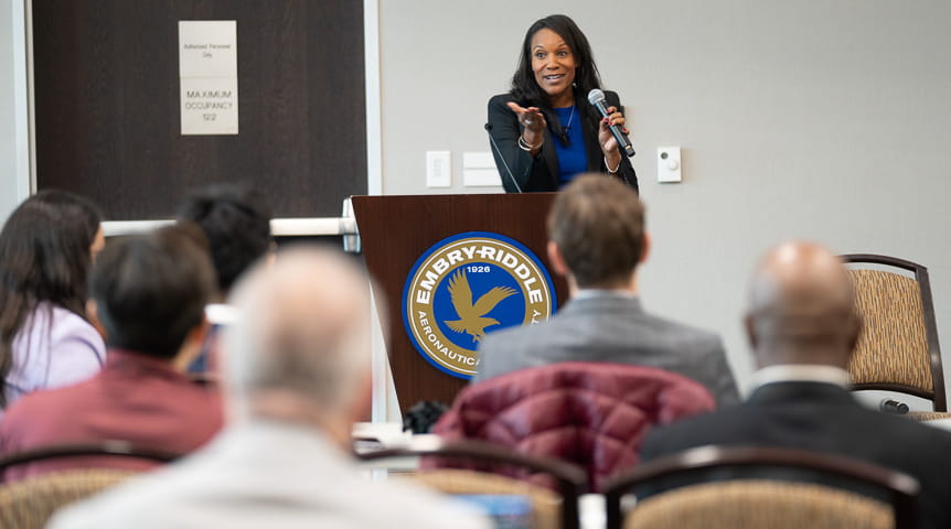 Woman stands in front of room at Embry-Riddle lectern
