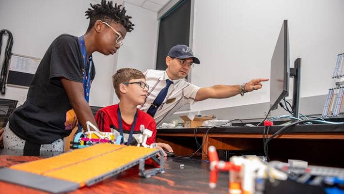 Dr. Jeremy Riousset worked with middle schoolers at a summer camp that introduced them to programming and space science