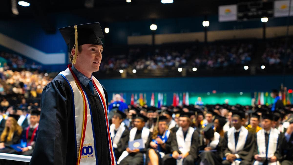 Student walks at commencement