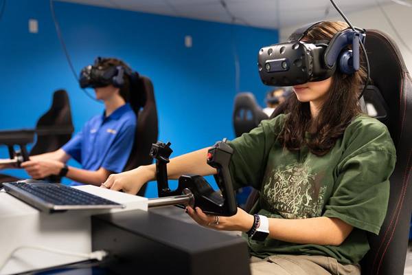 Embry-Riddle student Laurayna Pick, an Aeronautical Science freshman, conducts virtual-reality flight training maneuvers in the Advanced Flight Simulation Center this summer. 