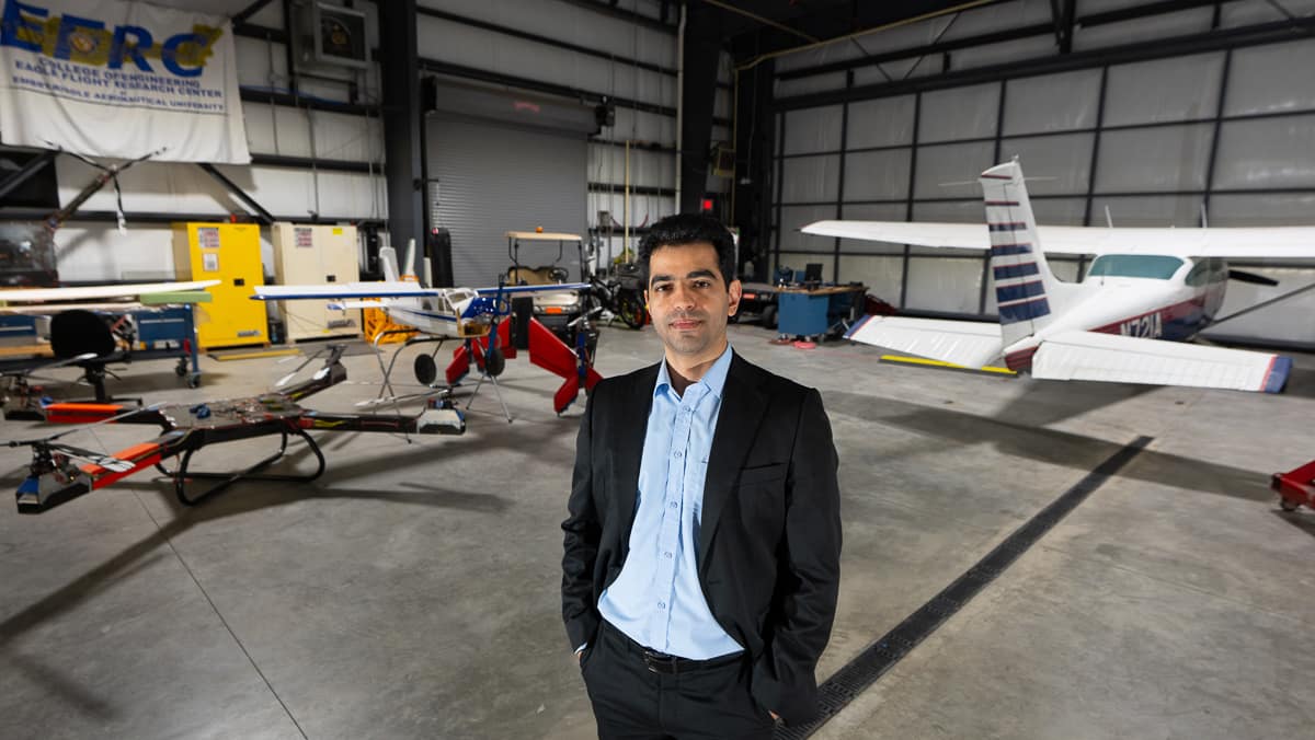 Man in front of plane and drones