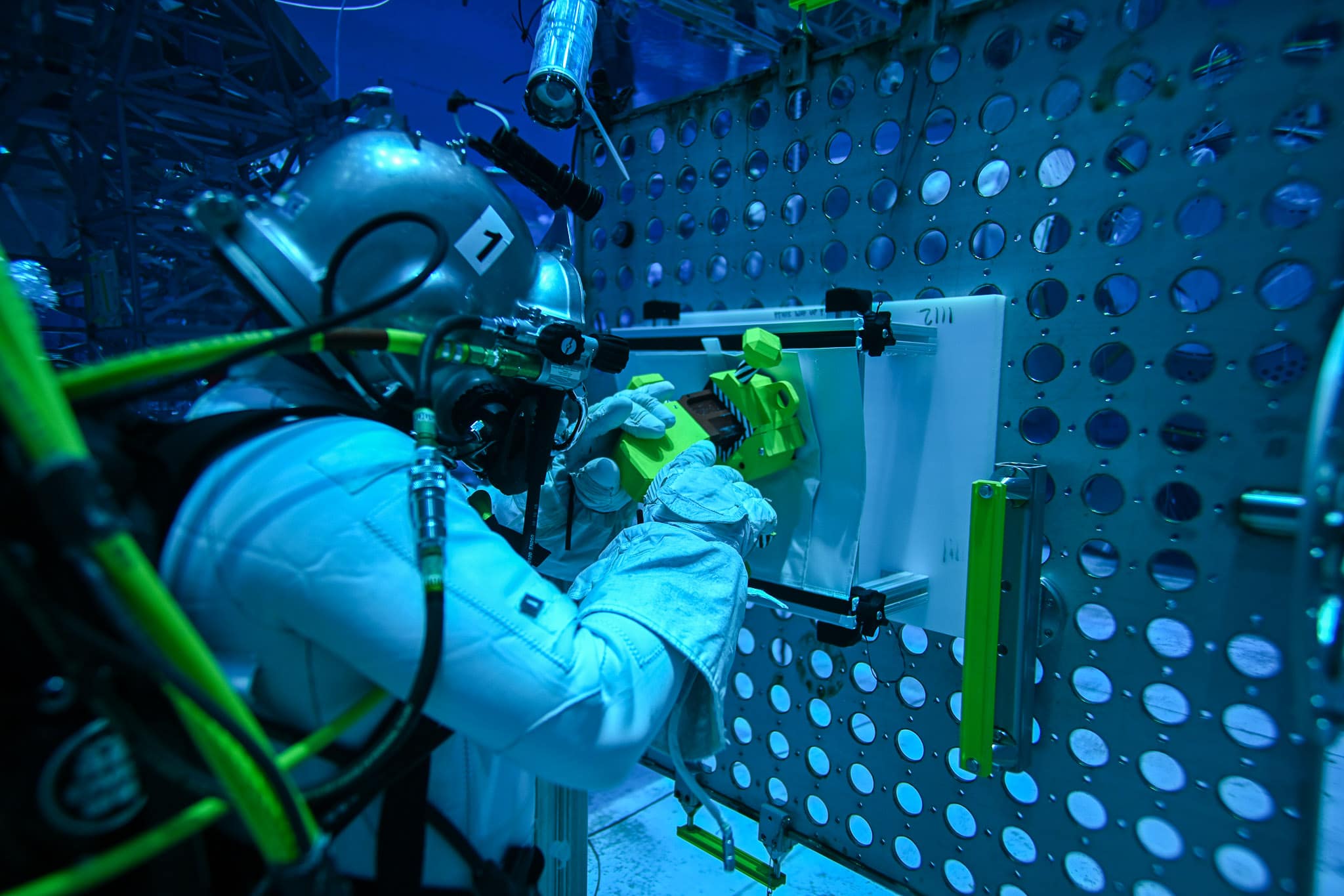 A NASA diver tests an Embry-Riddle student team’s soft goods attachment tool as part of this summer’s NASA Micro-g NExT Competition at the Johnson Space Center’s Neutral Buoyancy Laboratory.