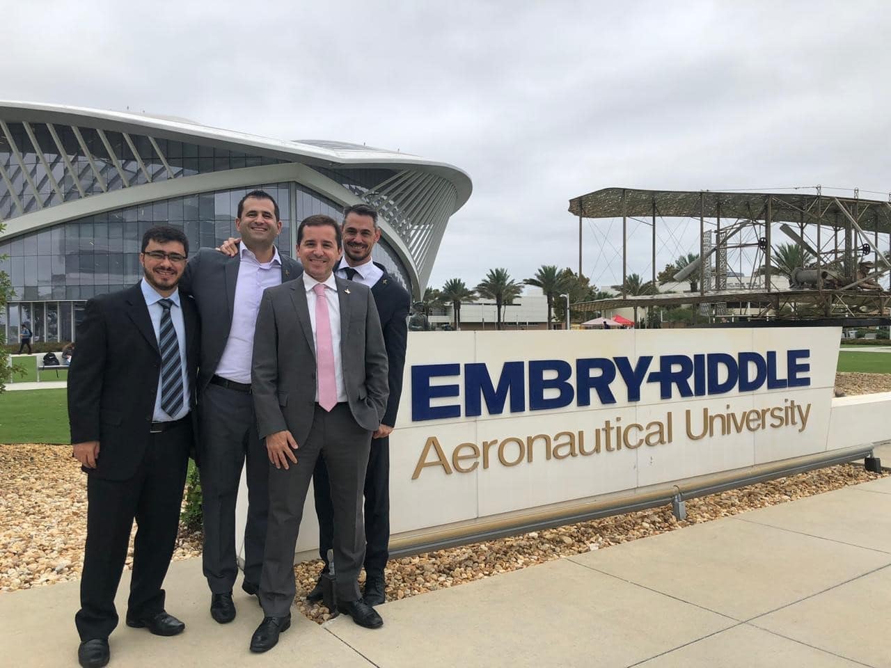 Fabiano Gomes de Oliveira, Diogo Youssef, Luciano Figueiredo Vale de Oliveira, and João Centeno stand next to the Embry-Riddle sign on Daytona Beach’s campus.