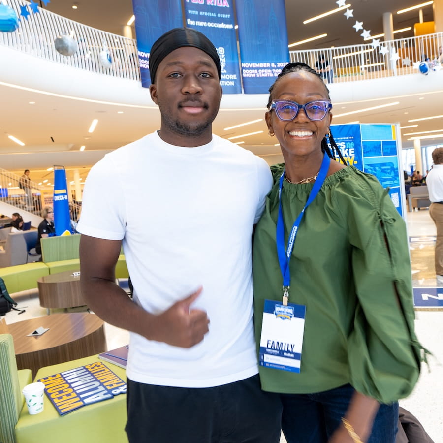 A student poses with his parent