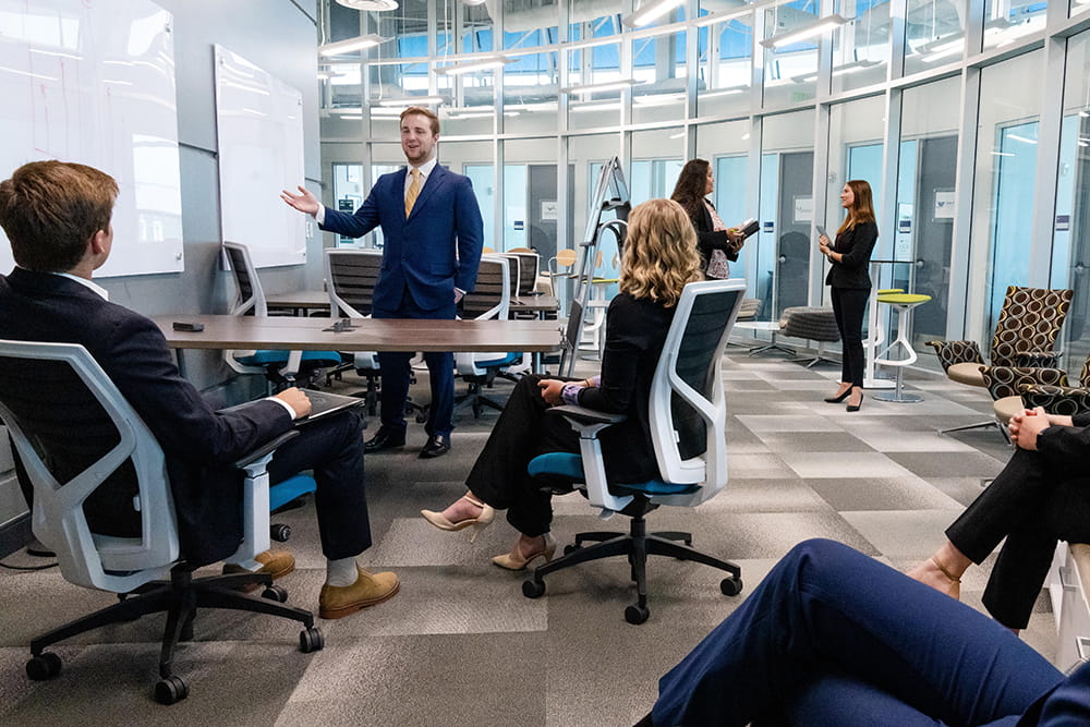 Young entrepreneurs at Embry-Riddle sit in a boardroom and collaborate at the Micaplex