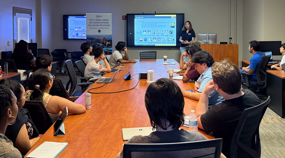 Students watch a presentation in a conference room