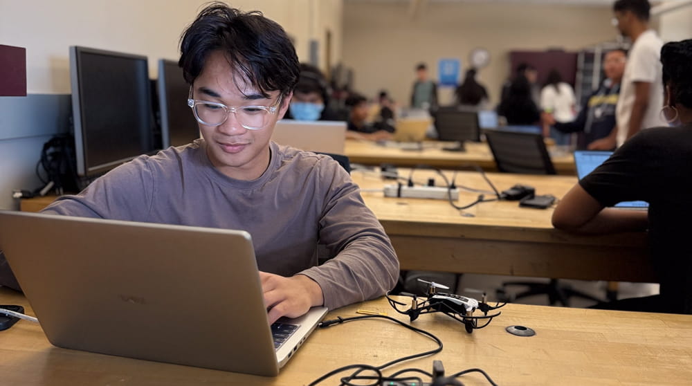 Student works on a laptop