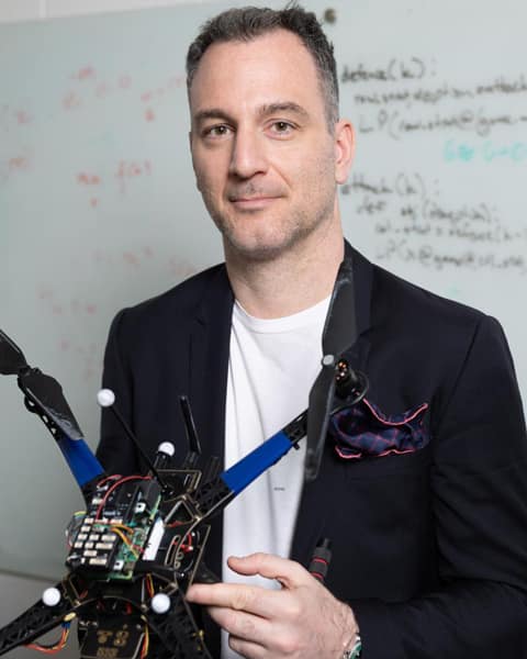 Kyriakos Vamvoudakis holding a robotics project
