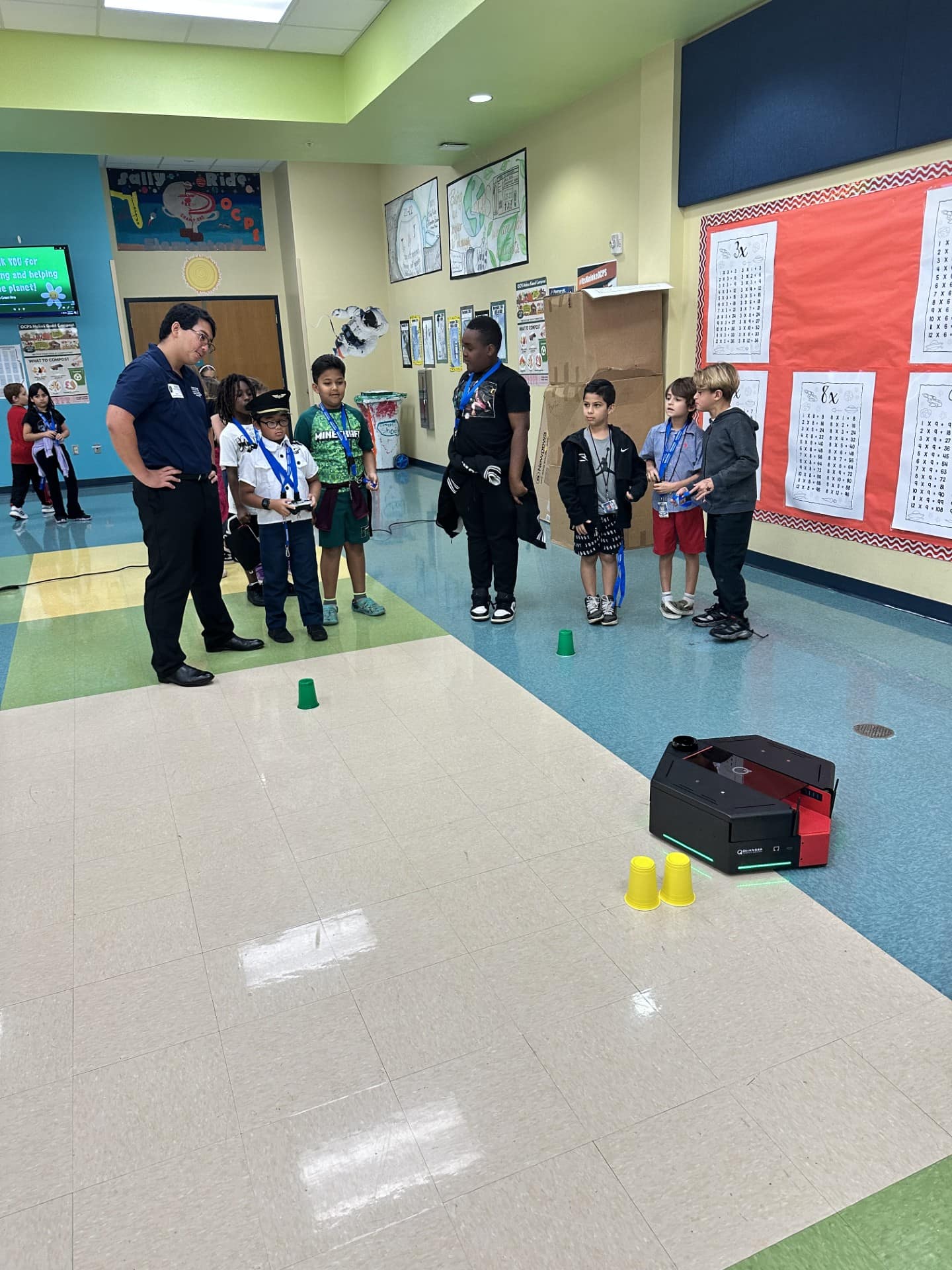 Students play a game with plastic cups during STEM outreach