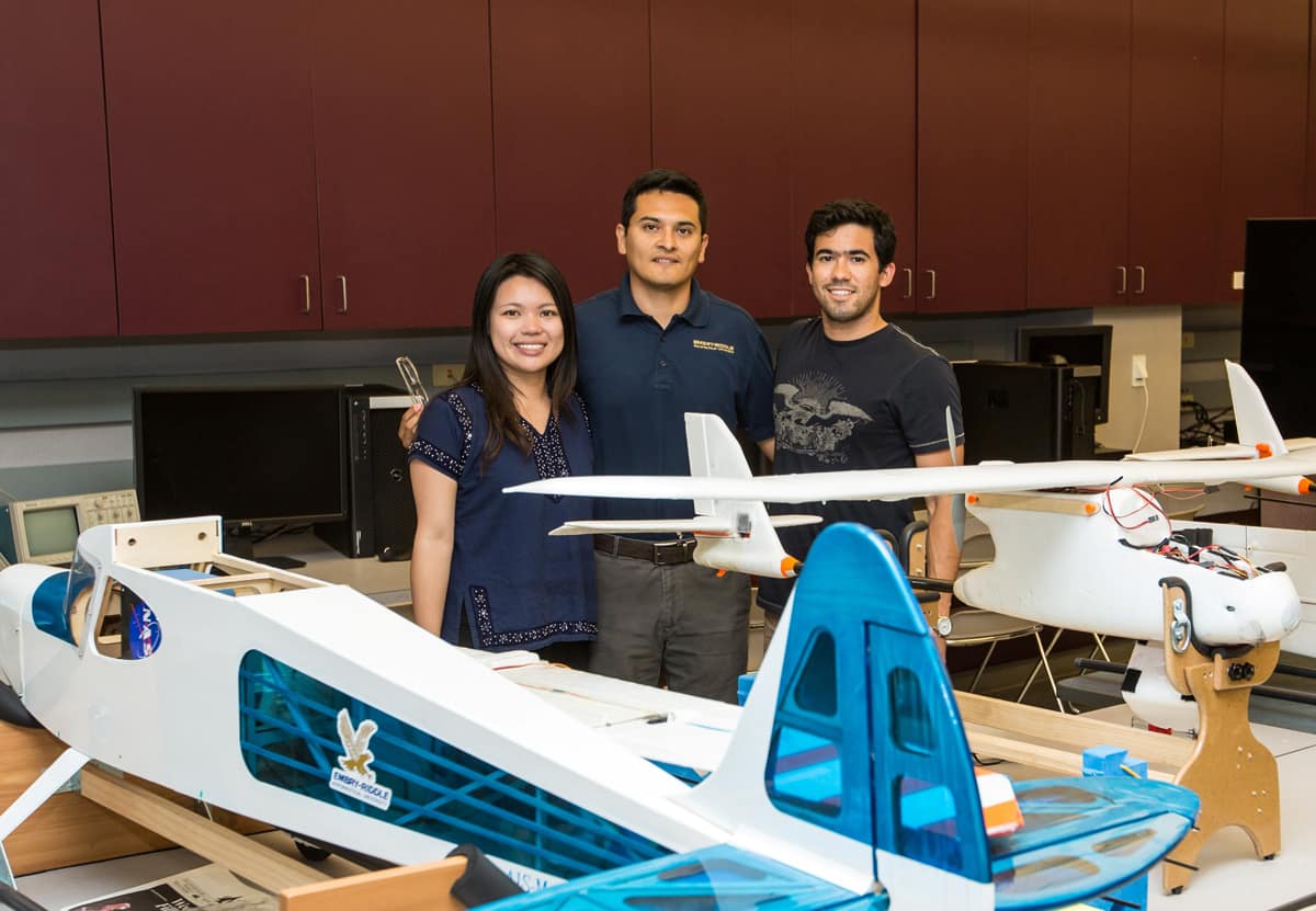 People pose with the model plane