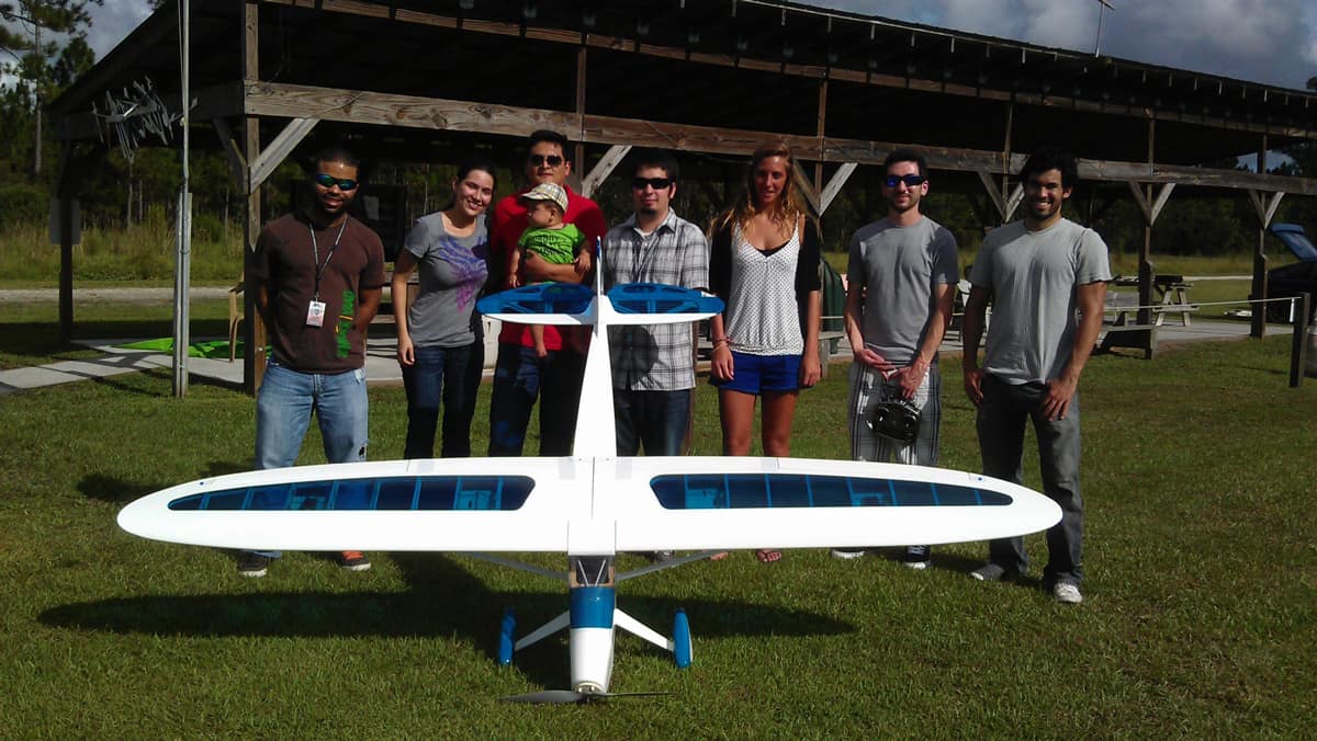 Group of people with a UAS in a field.