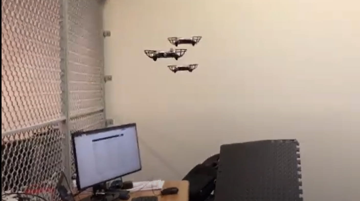 Drones fly inside by a desk