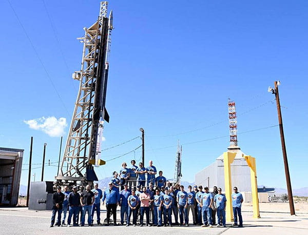 The APEP team standing in front of two missiles at White Sands Missile Range in New Mexico