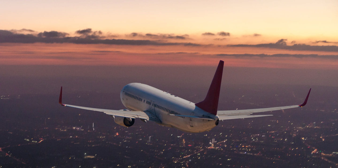 Airliner flying by sunset