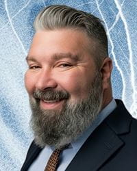 Joe Foreman professional portrait on a blue background