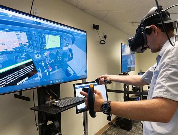 Student using a virtual reality flight simulator