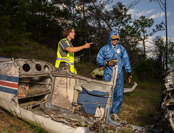 Students examine crashed plane.