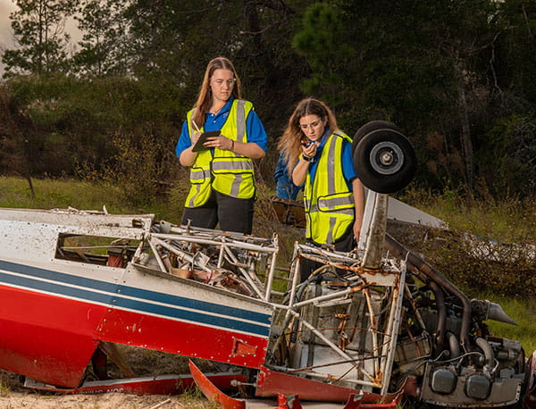 Students examine crashed plane.
