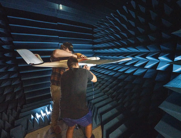 Two people working together on an unmanned aircraft.