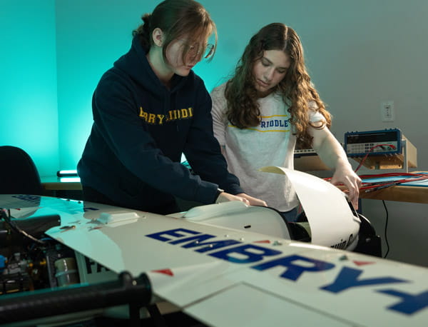 Two people working together on an unmanned aircraft.