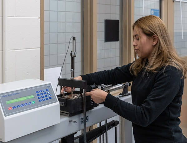 A person working on a machine in a laboratory.