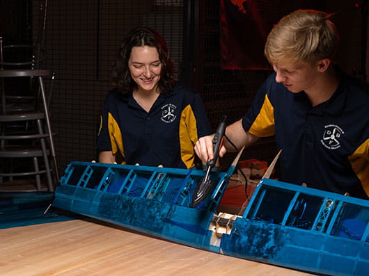 Two students work on an engineering project