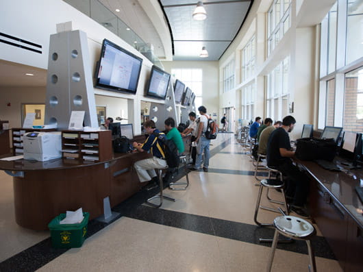 People sitting at computers in the flight operations center.