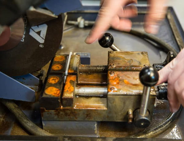A close-up of a machine’s control panel with a person’s fingers operating the controls
