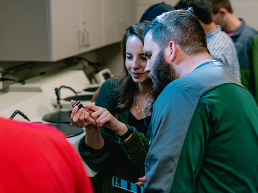 A group of students collaborating in a research laboratory.